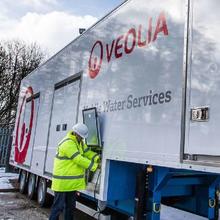 Veolia technician working on mobile water truck